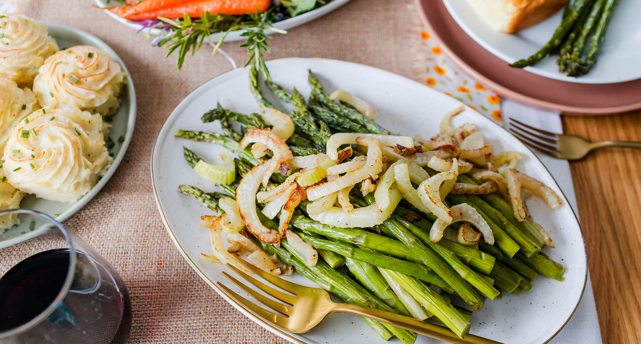 spring holiday sides of asparagus and fennel and potato rosettes on a table 